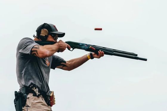 James Archbell firing a shotgun